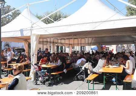 People Eating And Drinking At Local Festival