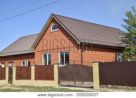 Detached House With A Roof Made Of Steel Sheets.