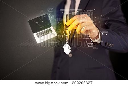 Businessman in suit holding keys with statistics, graphs and icons around