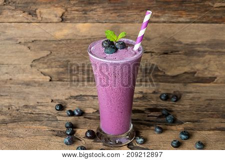 Blueberry smoothies and blueberry fruit yogurt for breakfast in the morning on a wooden floor.