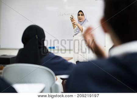 diverse muslim children studying in classroom