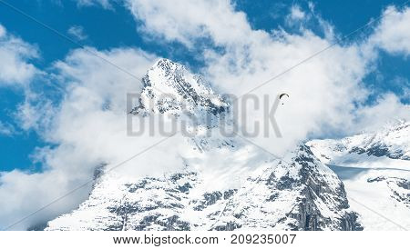Switzerland - May 2017: Paragliding above the Alp mountains