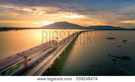 The train was running at high speed through a railway bridge Over Lake Pa Sak Dam Lopburi Thailand Beautiful Sunset
