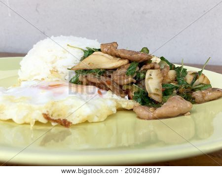 Thai Spicy Food Basil Pork Fried Rice Recipe (krapao Gai) With Fried Egg In Green Plate On Wooden Ba