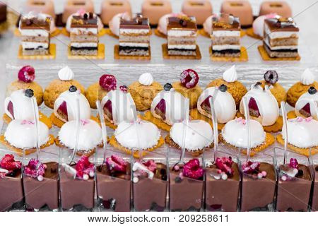 Dessert table for a party. Ombre cake, cupcakes. Wedding