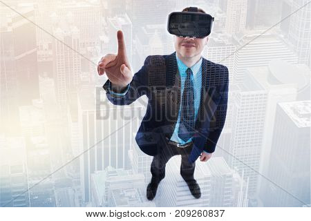 Mood-boosting gaming. Top view of a pleasant young man in a business suit raising his index finger while playing virtual reality games in his VR headset and smiling