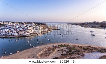 Aerial. Ferragudo at sunset shooting from the sky with drone.