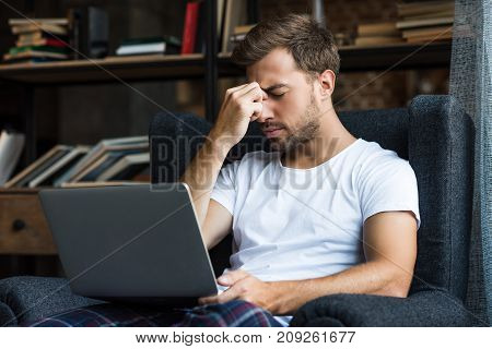 Tired Man Using Laptop