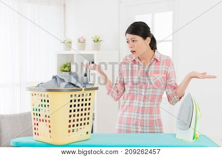 Elegant Female Student Looking At Messy Clothing