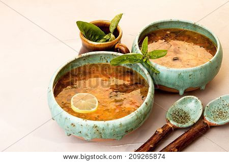 Solyanka Soup With Meat, Smoked Meat, Sausages, Pickled Cucumbers, Tomatoes, Olives, Herbs, Lemon In