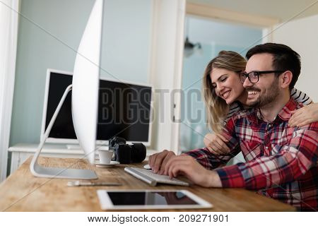 Young attractive designers working together from their home
