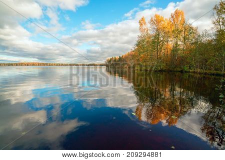 White clouds over the lake in the fall.