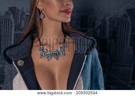 Portrait of a sexy girl in a necklace and earrings with precious stones