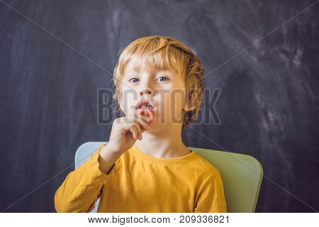 Three-year Old Boy Shows Vestibular Plate. Plate With A Bead To Stimulate The Tongue. Dysarthria, Rh
