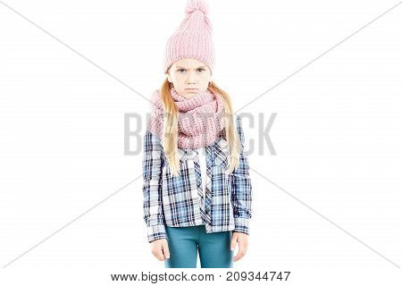 Studio portrait of little girl wearing knit hat and snood scarf
