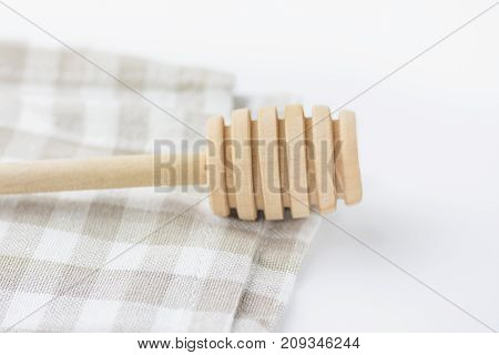 Wood Honey Dipper on White and Beige Chequered Cotton Kitchen Towel. Tabletop. Baking Essentials. Organic Produce. Holidays Christmas Easter. Clean Minimalist Style. Copy Space