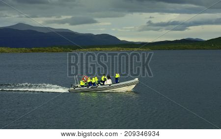 ABISKO, SWEDEN ON AUGUST 31. View of a rib boat comes in to the bridge on August 31, 2009 in Abisko, Sweden. Unidentified people, lake Tornetrask. Editorial use.