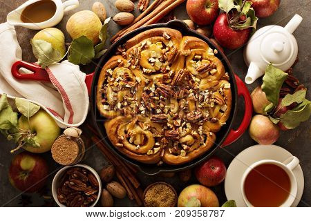 Cinnamon rolls with apples, caramel and pecan, fall baking concept overhead shot
