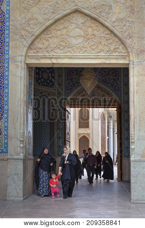 Fars Province Shiraz Iran - 19 april 2017: Shah Cheragh Shrine Muslim women pass through the large gate of mosque.