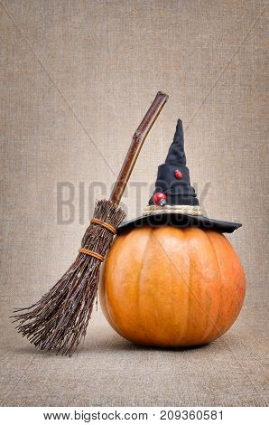 Broom And Hat Of  Witch On A Pumpkin For Halloween