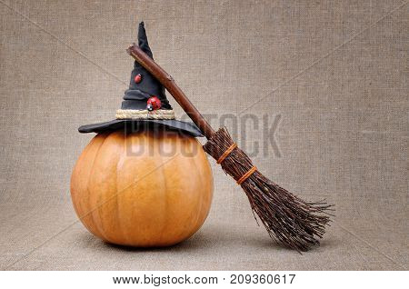 Broom And Hat Of  Witch On A Pumpkin For Halloween