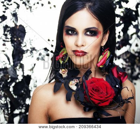 pretty brunette woman with rose jewelry, black and red, bright make up kike a vampire closeup red lips, halloween concept