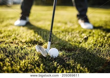 Man Playing Golf On A Golf Course In The Sun