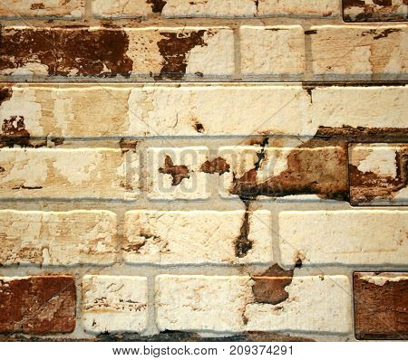 Brick wall of white brick with brown spots. background