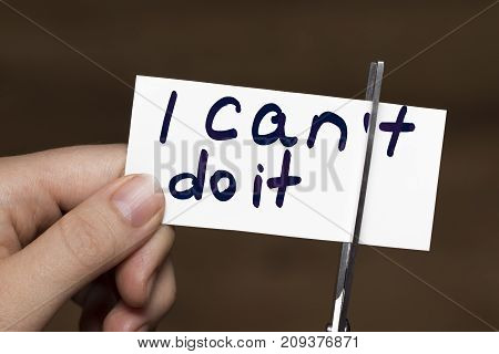 Man Using Scissors To Remove The Word Can't To Read I Can Do It Concept For Self Belief, Positive At
