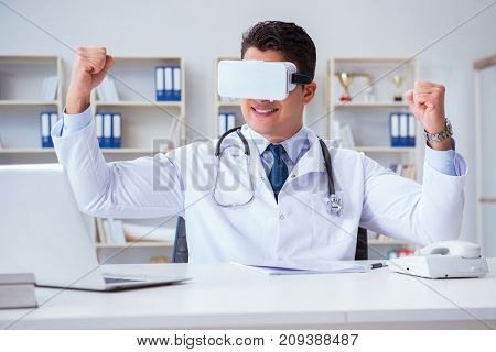 Young doctor with vr virtual reality headset working in the offi