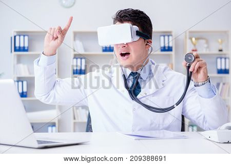 Young doctor with vr virtual reality headset working in the offi