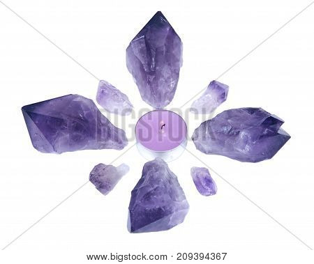 Lavender tea light surrounded by amethyst points isolated on white background