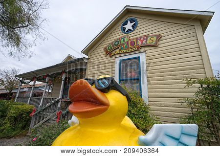 January 1 2016 Gruene Texas: a large yellow duck statue in the front of a toy store in the revived ghost town popular with tourists