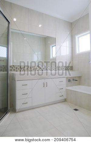 Granite bench top in bathroom with tiled walls and floors