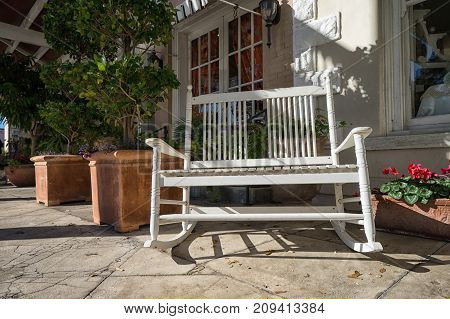 January 9, 2016 Goliad Texas USA: rocking chair in the shade of awning in front of a store in historic downtown