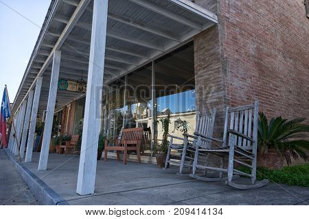 January 9 2016 Goliad Texas USA: rocking chair in the shade of awning in front of a store in historic downtown