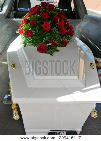 closeup shot of a colorful casket in a hearse or chapel before funeral or burial at cemetery