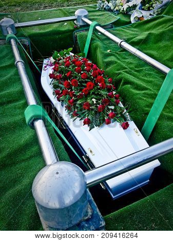 closeup shot of a colorful casket in a hearse or chapel before funeral or burial at cemetery