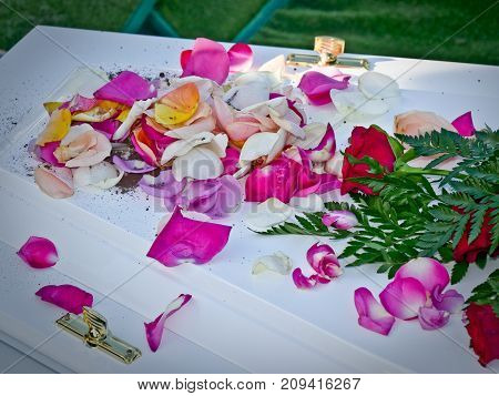 closeup shot of a colorful casket in a hearse or chapel before funeral or burial at cemetery