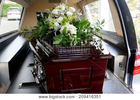 closeup shot of a colorful casket in a hearse or chapel before funeral or burial at cemetery