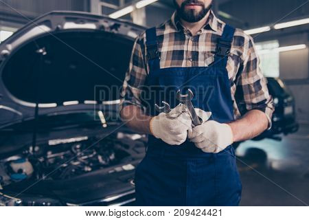 Close Up Cropped Shot Of Expert Mechanic With Metal Mechanical Keys In Arm, In Special Safety Outfit
