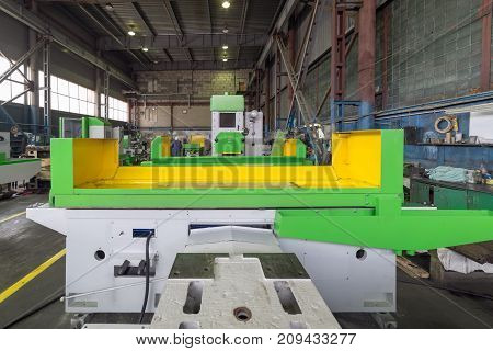 Surface grinding machine at the stage of assembly. Modern production of grinding machines.