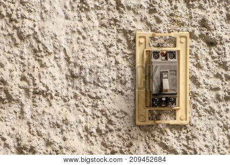 Electrical breaking switch on stucco wall copy space