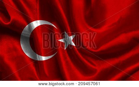 Realistic flag of Turkey on the wavy surface of fabric. This flag can be used in design.