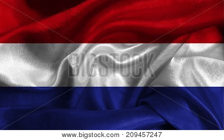 Realistic flag of Netherlands on the wavy surface of fabric. This flag can be used in design.