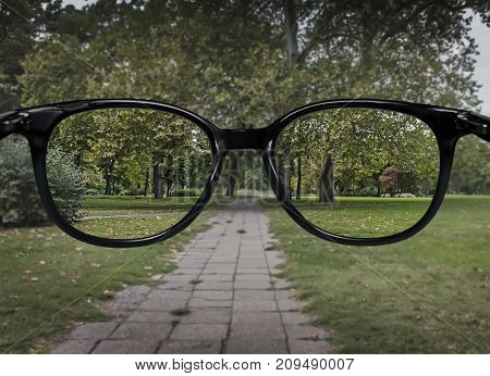 Clear Vision Through Glasses On Green Park Background