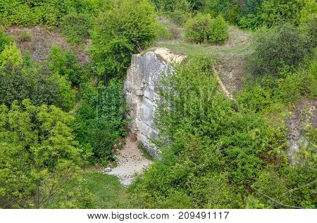 Rocks among green trees. Rocks of Twardowski at the lagoon of Zakrzowek in Krakow Poland.