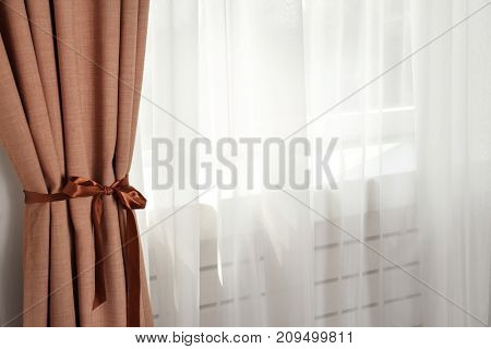 Window with beautiful curtains indoors