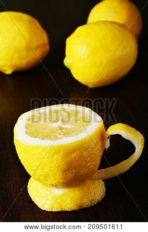 a cup of lemona cup of lemon on a wooden table