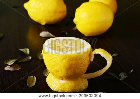 a cup of lemona cup of lemon on a wooden table